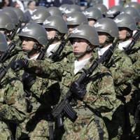 Soldiers march at the Asaka Base in Saitama Prefecture during Self-Defense Forces Day, on Oct. 27, 2013. | AP