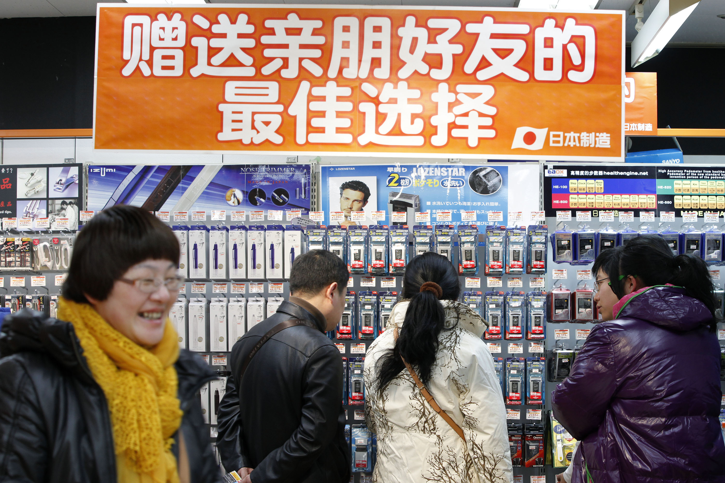 Chinese tourists browse through a Laox electronics store in Tokyo's Akihabara district on Jan. 23, 2012. | BLOOMBERG