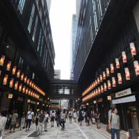 Shoppers stroll through the middle of the complex, illuminated by lanterns decorated with goldfish, on July 20. | YOSHIAKI MIURA