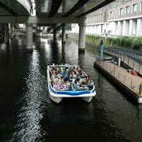 A party boat navigates a waterway in the district. | YOSHIAKI MIURA