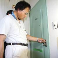Koji Nagashima, who has been living in an elementary school since mudslides hit his neighborhood in the city of Hiroshima, moves into a temporary housing unit in the city on Thursday. | KYODO