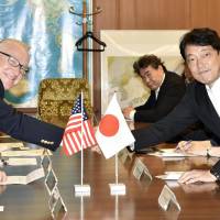 Howard McKeon (left), chairman of the U.S. House of Representatives Armed Services Committee, shakes hands with Defense Minister Itsunori Onodera at the Defense Ministry on Sunday. | KYODO