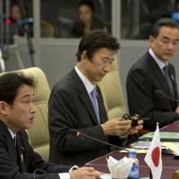 Foreign Minister Fumio Kishida (left), seated next to South Korean counterpart Yun Byung-se, attends the foreign ministerial meeting of the Association of Southeast Asian Nations plus Japan, South Korea and China, along with Chinese Foreign Minister Wang Yi (right) in Naypyitaw on Saturday. | AP