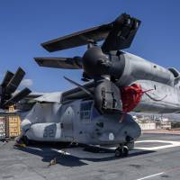 An MV-22 Osprey sits aboard the new amphibious assault ship USS America (LHA6) at Pier Maua in Rio de Janeiro on Wednesday. The America, which can can also emulate the functions of a standard aircraft carrier, is on its maiden voyage around the Americas. | AFP-JIJI