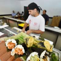 \"Temaki\" hand-rolled sushi are offered at a Japanese restaurant in Rio de Janeiro on July 13. | KYODO