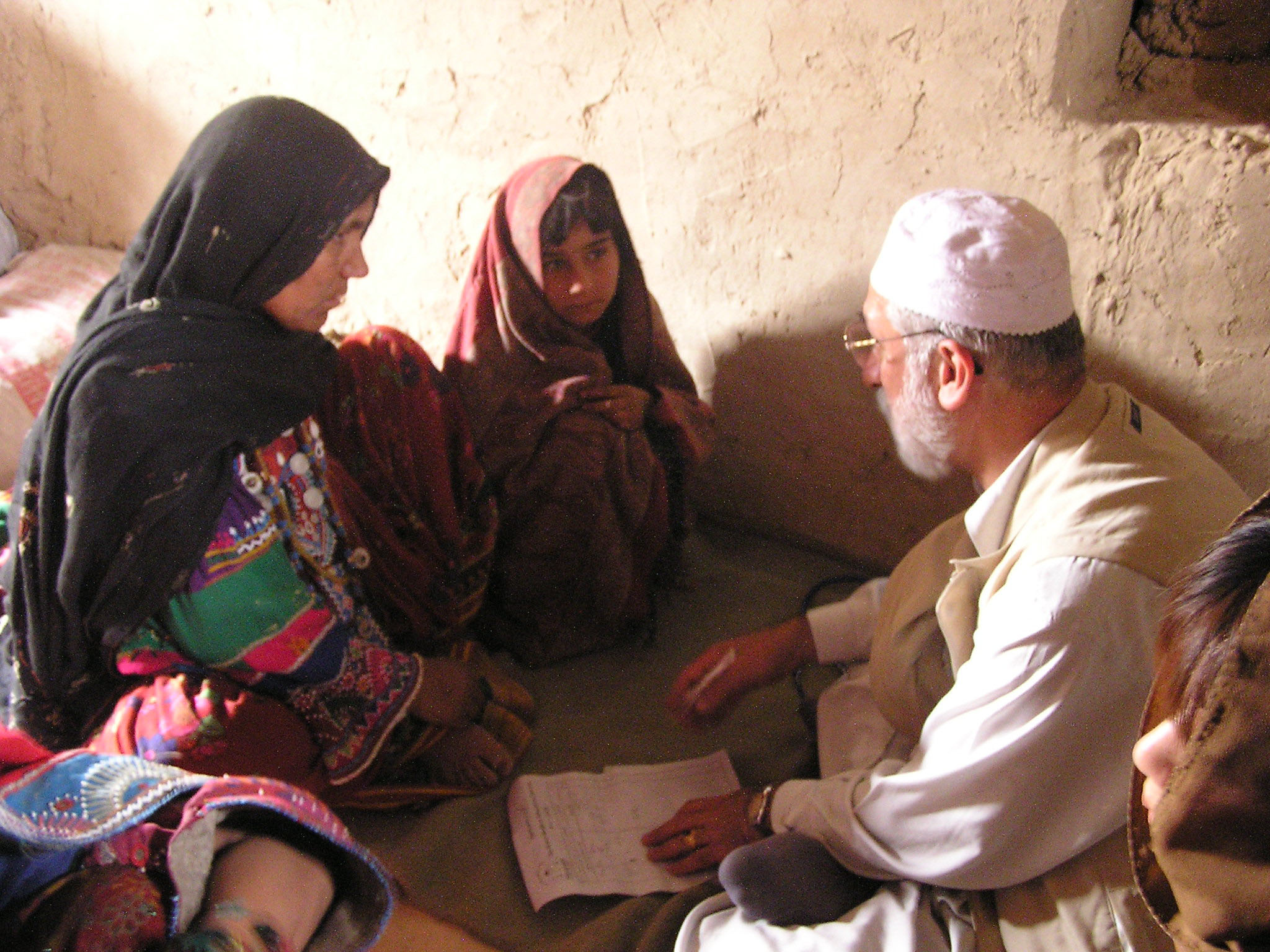 Khaled Reshad provides health advice to a woman and a girl during a visit to a village, which at the time had no resident doctor, in rural Afghanistan in May 2004. | COURTESY OF KHALED RESHAD