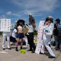 Dressed up for Comiket 86: Group participation is popular among cosplayers, as is \"cross-play,\" (cross dressing in character), for which Kancolle characters proved popular with both genders. | BEN BRADY