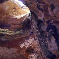 Buried treasure: A cave specialist rappels into Natural Trap Cave in Wyoming during a cleanup expedition. | AP