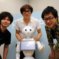Humor lab (from left): Masato Takahashi, Toshinari Nakano and Kyeong Heon Shin of the new robotics division at entertainment agency Yoshimoto Kogyo pose with pioneering android Pepper. Yoshimoto Kogyo's role in creating a real-life robot with a sense of humor