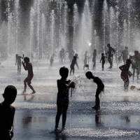Children cavort in a fountain during a sunny summer\'s day on Thursday in Nice, southeastern France, as the mercury reached a high of 26 degrees Celsius during the late afternoon along the French Riviera. | REUTERS
