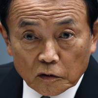 Deputy Prime Minister and Finance Minister Taro Aso holds a news conference at the prime minister\'s office on Wednesday. | REUTERS