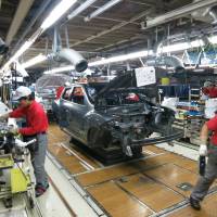 Employees work on the assembly line at Nissan Motor Co.\'s Oppama plant in Yokosuka, Kanagawa Prefecture, on Monday. | KAZUAKI NAGATA