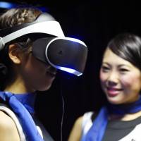 Models show off Sony\'s Project Morpheus, a head-mounted display designed for use with the PS4 gaming console, at the annual Tokyo Game Show at Makuhari Messe hall in the city of Chiba Thursday. | KYODO