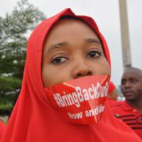 A woman attends a demonstration in Abuja on Sept. 11 calling on the government to rescue the kidnapped girls of the government secondary school in Chibok. More than 200 schoolgirls were kidnapped from the school in Nigeria\'s north-eastern state of Borno on April 14. Boko Haram claimed responsibility for the act. | AP