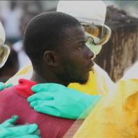 Health workers surround a Liberian Ebola patient who escaped from quarantine from Monrovia\'s Elwa hospital in this image taken from a Sept. 1 video. | REUTERS