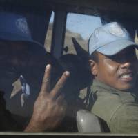 Fijian U.N. peacekeepers, released by al-Qaida-linked group Nusra Front in Syria on Thursday, gesture from inside a vehicle as they arrive in Israeli-held territory on the Golan heights. The peacekeepers were taken hostage two weeks ago when several Islamist militant groups, including Nusra, attacked in the volatile frontier between Syria and Israel. | REUTERS