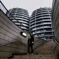 A man walks down a flight of stairs near buildings surrounding \"Silicon Roundabout\" in London in May last year. | REUTERS