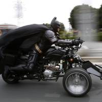 A 41-year-old man going by the name of Chibatman rides his \"Chibatpod\" Sunday on the road in Chiba, east of Tokyo. | REUTERS