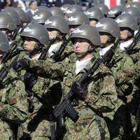 Members of the Self-Defense Forces march at Asaka Base, Saitama Prefecture, on Oct. 27, 2013. | AP