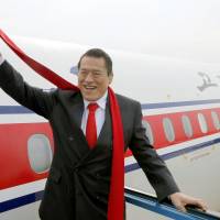 Diet lawmaker Antonio Inoki waves as he leaves Pyongyang international airport Tuesday after taking part in a rare two-day pro-wrestling event in North Korea. | KYODO