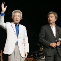 Former Prime Minister Junichiro Koizumi (left) and Morihiro Hosokawa stand on the stage at the \"No Nukes 2014\" rock festival, organized by Ryuichi Sakamoto, on Monday in Tokyo. | KYODO