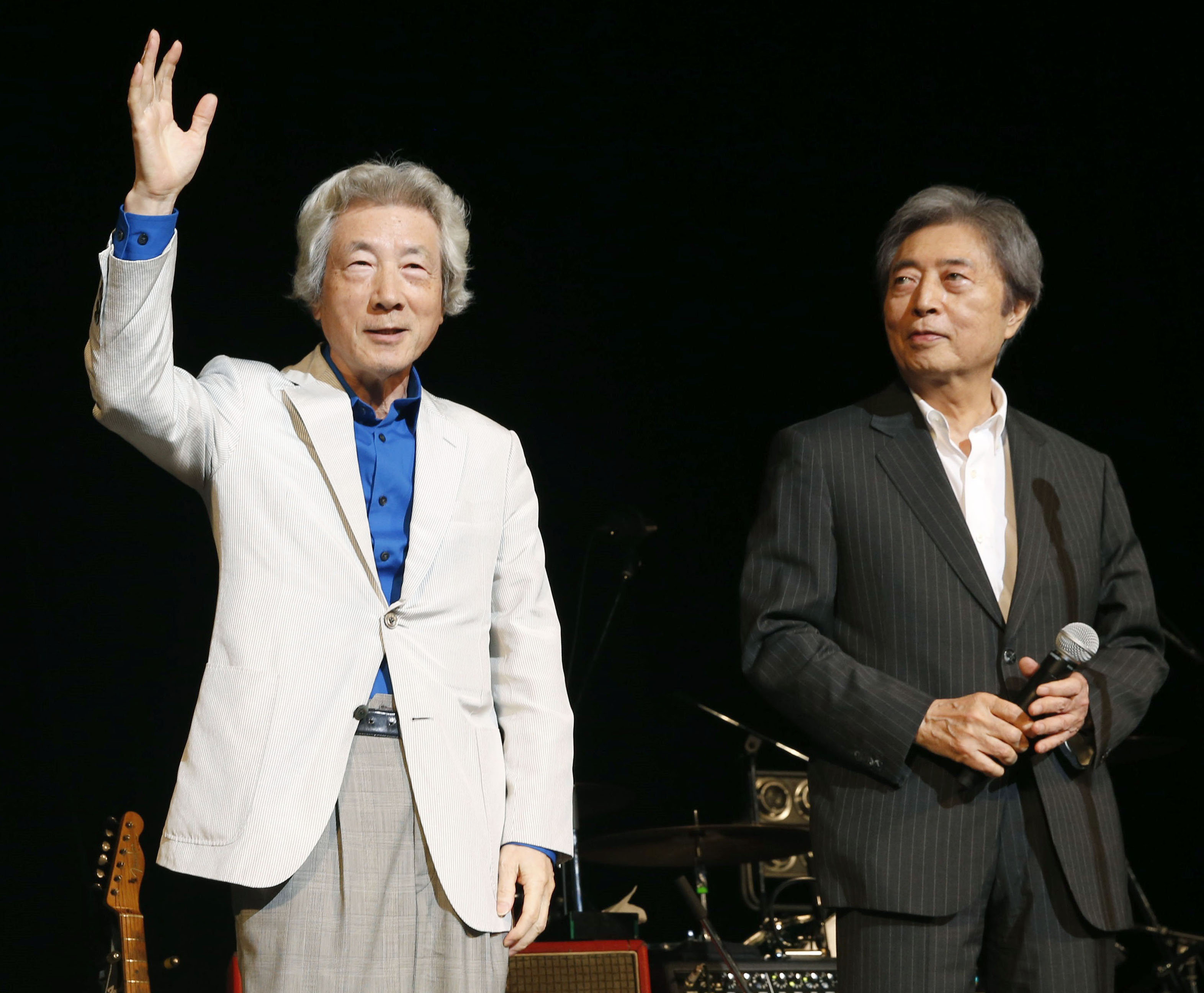 Former Prime Minister Junichiro Koizumi (left) and Morihiro Hosokawa stand on the stage at the 'No Nukes 2014' rock festival, organized by Ryuichi Sakamoto, on Monday in Tokyo. | KYODO