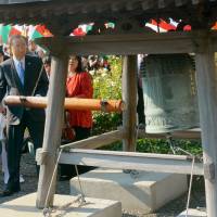 United Nations Secretary General Ban Ki-moon rings the Peace Bell, which was donated by Japan, in the rose garden of U.N. headquarters in New York on Friday. | KYODO