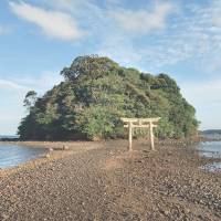 Visitors can only approach Kojima Shrine in Nagasaki Prefecture at low tide, when the causeway is uncovered. The shrine itself is at the rear of the islet. | KYODO