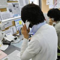 Counselors for a free 24-hour hotline speak to survivors of the March 2011 disasters. | KYODO