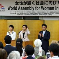 Masako Mori (left), former minister in charge of the declining birthrate, Haruko Arimura (second left), minister in charge of the promotion of women, trade minister Yuko Obuchi (second right) and Prime Minister Shinzo Abe attend a reception for the World Assembly for Women in Tokyo on Sept. 12. | AFP-JIJI