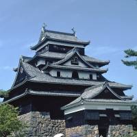 Layer cake: Garden paths lead to the five-story keep of Matsue Castle, one of the country\'s 12 original fortresses. | STEPHEN MANSFIELD