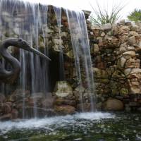 Rippling creek: A waterfall flows over man-made caves at the Lady Bird Johnson Wildflower Center in Austin, Texas. Lady Bird's legacy lives on at wildflower center