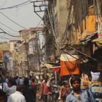 Living city: A crowded street scene in the old town of Agra, India, where shops, vehicles and pedestrians are forced to compete for space. | TATSUO KANAI