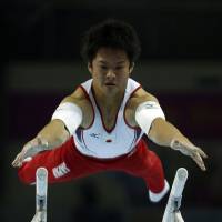 Keen concentration: Yuya Kamoto competes in the men\'s parallel bars final of the artistic gymnastics competition at the Namdong Gymnasium Club on Thursday in Incheon, South Korea. Kamoto earned his third gold medal at the 17th Asiad. | REUTERS