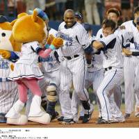 Still hanging around: The BayStars\' Tony Blanco celebrates after his game-winning home run against the Dragons on Sunday. | KYODO