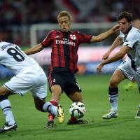 I\'ll take that: AC Milan\'s Keisuke Honda fights for the ball during a 5-4 win over Parma on Sunday. | AFP-JIJI