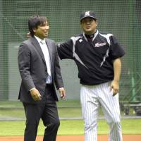 Final season: Chiba Lotte Marines catcher Tomoya Satozaki, seen with manager Tsutomu Ito, has played in just 16 games in 2014. | KYODO