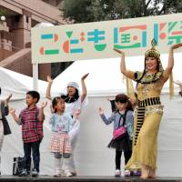 Arabic dance instructors teach Egyptian gymnastics to children on stage at the Children\'s International Festa 2014 held Sunday in Tokyo\'s Ebisu district. Among the official supporters of the event were the Foreign Ministry and The Japan Times. | YOSHIAKI MIURA
