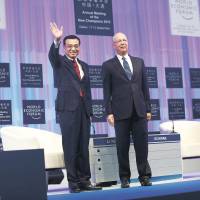 Li Keqiang (left), Premier of the People\'s Republic of China stands with Klaus Schwab, Founder and Executive Chairman, World Economic Forum at the Opening Plenary of the Annual Meeting of the New Champions 2013 in Dalian, China. | WORLD ECONOMIC FORUM