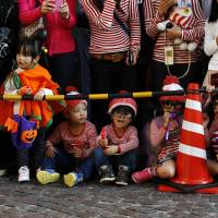 Mini Waldos await the parade\'s arrival in Kawasaki on Sunday.  | REUTERS