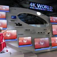 4K TVs such as these by Panasonic Corp. offer a dazzling sight at the CEATEC exhibition at Makuhari Messe in Chiba Prefecture on Tuesday. The show runs through Saturday. | KAZUAKI NAGATA