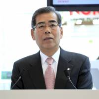 Nobuaki Kato, president and CEO of Denso Corp., speaks at the Tokyo Motor Show in Chiba in 2009. | BLOOMBERG