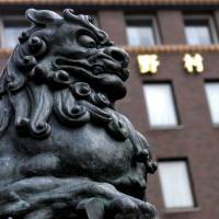 A statue stands outside Nomura Holdings Inc. in Tokyo as the brokerage recovers from its 2008 Lehman purchase. | BLOOMBERG