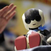 Tomy Co.\'s new Robi jr. prototype is unveiled during Japan Robot Week 2014 on Wednesday at Tokyo Big Sight. It has speech recognition and a vocabulary of 1,000 Japanese phrases. | AP