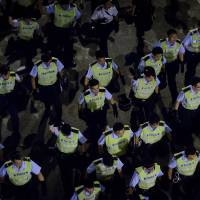 Police confront pro-democracy protesters outside the central government offices in Hong Kong on Wednesday. | AFP-JIJI
