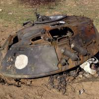 A painted white circle marks the turret of a BMP-2 armored personnel carrier on a battlefield in eastern Ukraine on Oct. 2. Locals said that passing troops who identified themselves as Russian had told them the circles identified Russian equipment. | REUTERS