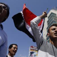 Protesters shout slogans Tuesday as they demonstrate to demand the rebels of the Shiite Houthi movement leave Yemen\'s capital, Sanaa, after seizing control of it last week. | REUTERS