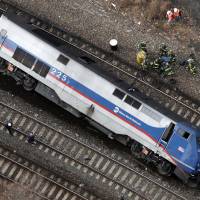 A Metro-North locomotive lies on its side last Dec. 1 after derailing in the Bronx borough of New York. The National Transportation Safety Board said Tuesday that the sleep-deprived engineer nodded off at the controls of the commuter train just before taking a 30 mph curve at 82 mph, causing the derailment that killed four people and injured more than 70. | AP