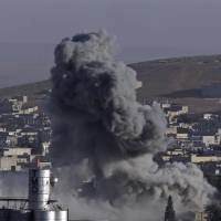 Smoke rises following an airstrike by U.S.-led coalition aircraft in Kobani, Syria, during fighting between Syrian Kurds and militants of the Islamic State group, as seen from the outskirts of Suruc, on the Turkey-Syria border, on Friday. | AP