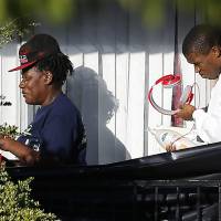 People leave the apartment unit in Dallas on Friday where Thomas Eric Duncan, a Liberian citizen diagnosed with the Ebola virus, stayed. | REUTERS